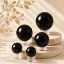 Black Obsidian spheres by Talk to Crystals, available in various sizes, featuring natural healing crystals for protection, grounding, removing negative energy, emotional strength, Root Chakra healing, and spiritual cleansing in India