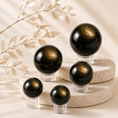 Golden Sheen Obsidian spheres by Talk to Crystals, available in various sizes, featuring natural healing crystals for protection, personal power, confidence, manifestation, clarity, and Solar Plexus Chakra healing in India
