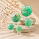 Green Fluorite spheres by Talk to Crystals, available in various sizes, featuring natural healing crystals for mental clarity, emotional balance, focus, personal growth, and Heart Chakra healing in India.