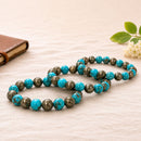 ranian turquoise and pyrite combo bracelet with natural beads, handcrafted crystal healing jewelry for prosperity, protection and positive energy. Premium spiritual bracelet for men and women in India, ideal for daily wear and gifting.