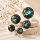 Labradorite spheres by Talk to Crystals, available in various sizes, featuring natural healing crystals for intuition, transformation, protection, higher consciousness, discovering inner potential, and Third Eye Chakra healing in India