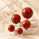 Red Jasper spheres by Talk to Crystals, available in various sizes, featuring natural healing crystals for strength, courage, grounding, stability, motivation, and Root Chakra healing in India