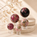 Rhodonite spheres by Talk to Crystals, available in various sizes, featuring natural healing crystals for forgiveness, emotional healing, self-worth, relationship harmony, and Heart Chakra healing in India