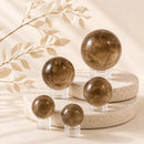 Smoky Quartz spheres by Talk to Crystals, available in various sizes, featuring natural healing crystals for grounding, protection, stress relief, releasing negative energy, Root Chakra healing, and emotional resilience in India