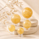 Yellow Calcite spheres by Talk to Crystals, available in various sizes, featuring natural healing crystals for confidence, mental clarity, optimism, motivation, Solar Plexus Chakra healing, and positive energy in India